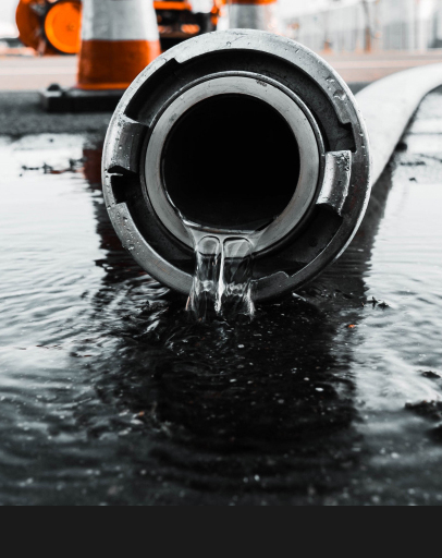 Water flowing out of a large drain pipe