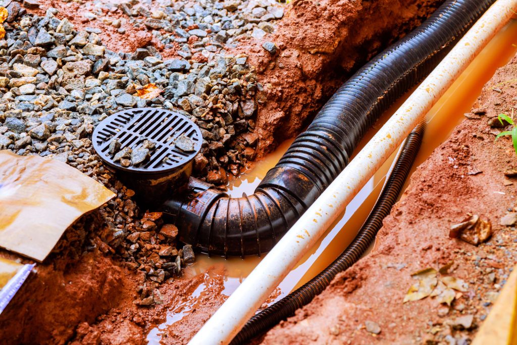 Excavated trench showing a sewer drain line and cleanout