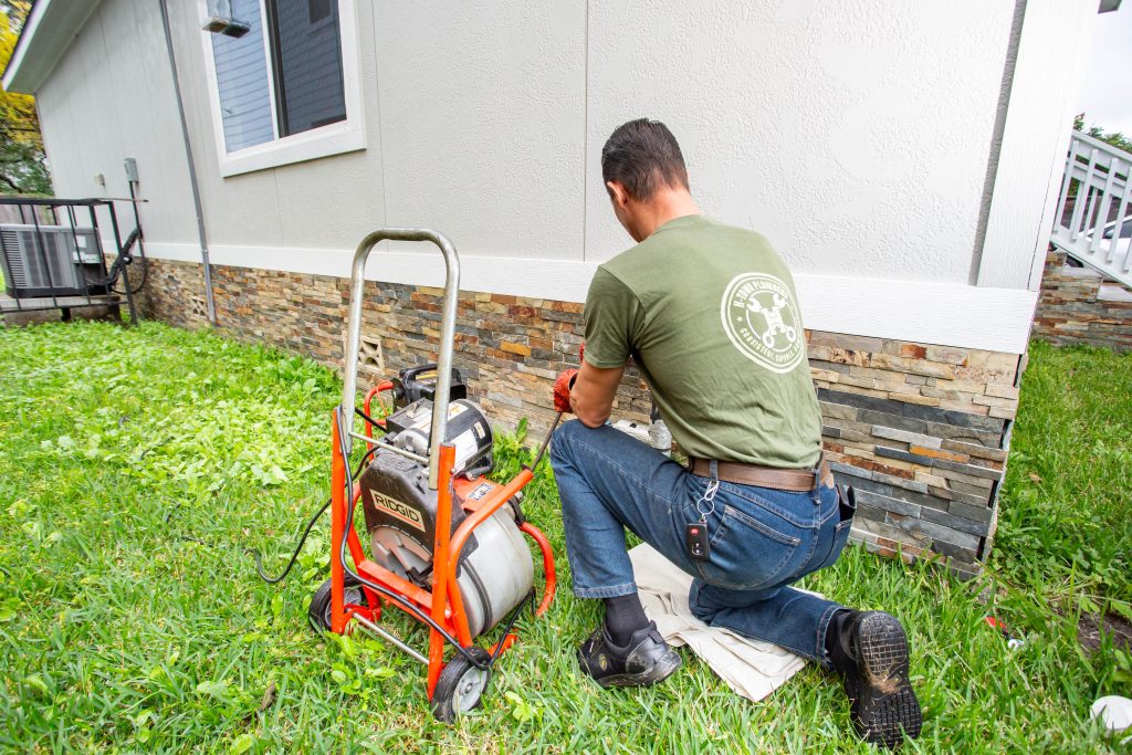 H-Town Plumbers plumber cleaning a sewer line with a drum machine